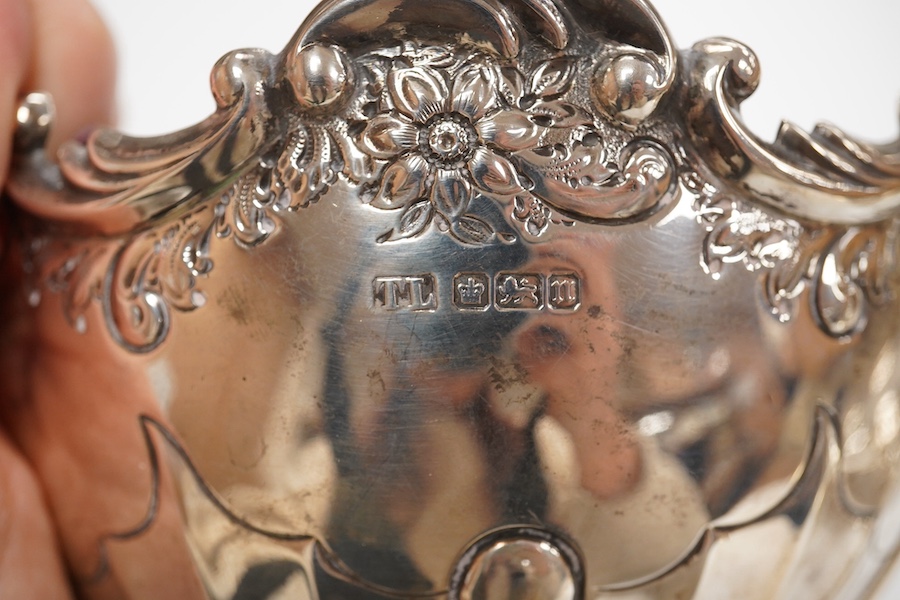 A George III small silver sugar basket, London, 1810, with blue glass liner, 57mm, a George III silver sifter spoon, a pair of silver bonbon dishes and an Edwardian small rose bowl, 16.9oz. Condition - poor to fair to go